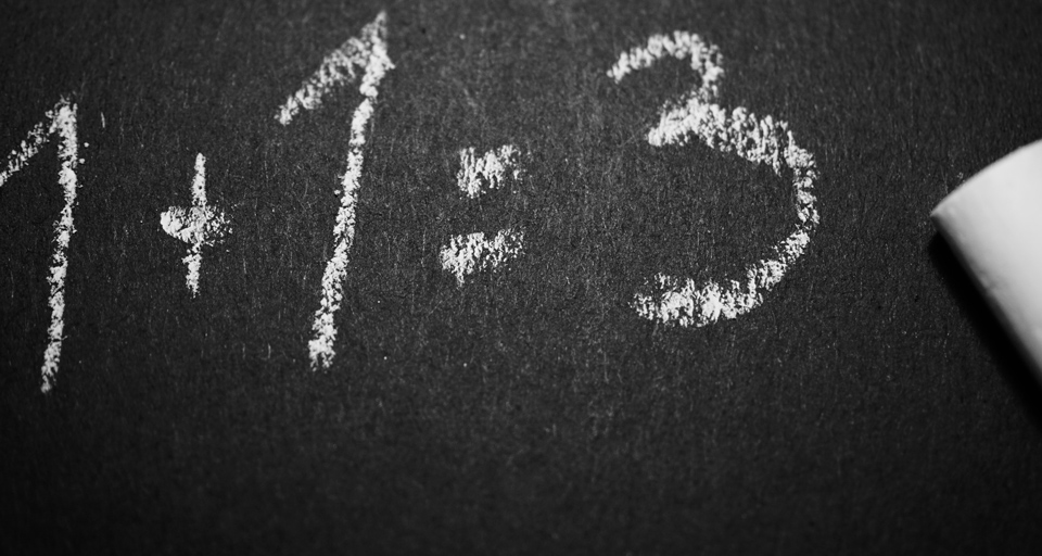 Chalkboard demonstration of positive sum gain using one plus one equation